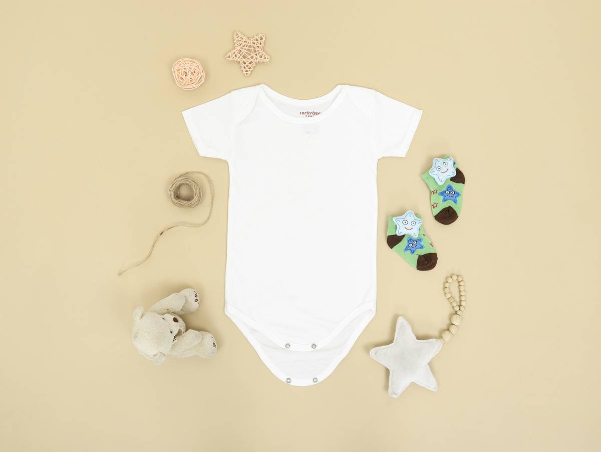 Close-up of soft organic cotton baby onesie with tag showing certification, illustrating green baby jojo ability